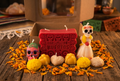 Kraft box Día de los Muertos candle set styled on rustic table with marigold petals